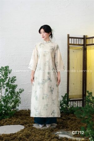 Áo dài cách tan suông tong kem theu hoa tiet xanh Ngọc