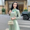 Áo dài truyền thông cúc xanh thêu sen